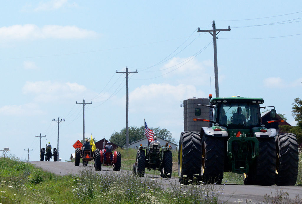 Five tractors head out on Highway Y for the Boone County tractor drive